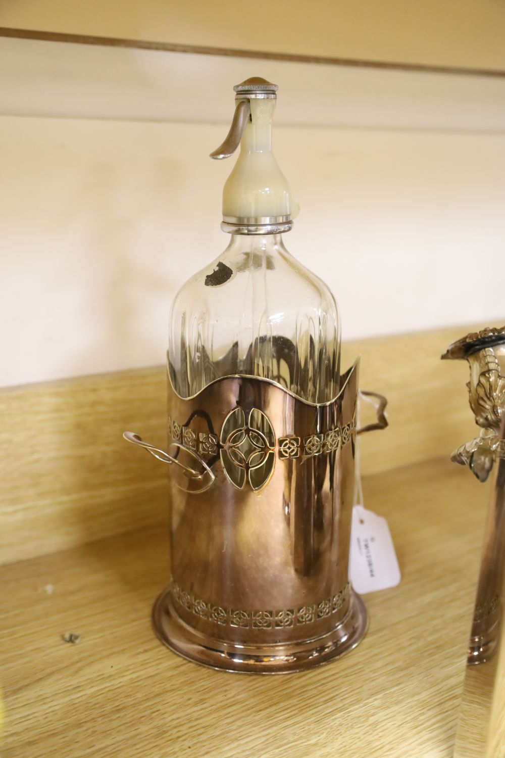 An ornate three-branch plated candelabrum with tulip sconces and sundry plated items,